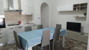 a kitchen with a table with a blue table cloth on it at Casa Vacanze Leo 2 in Acquarica del Capo +15 photos