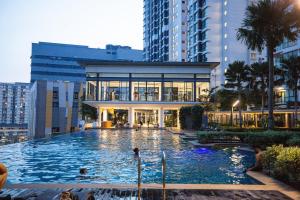 a large swimming pool in front of a building at Velocity KL By PSM Luxury Suites in Kuala Lumpur