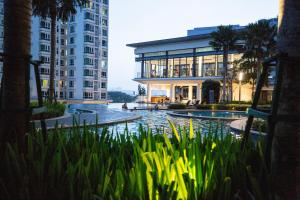a building with a pond in front of a building at Velocity KL By PSM Luxury Suites in Kuala Lumpur