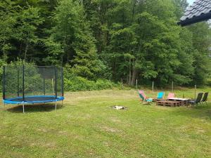 a park with a trampoline and a table and chairs at LENIÓWKA in Ponikiew