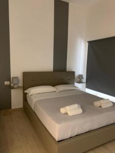 Giường trong phòng chung tại Maison Arena Al Corso