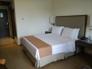 a bedroom with a large bed in a hotel room at Trident Agra in Agra
