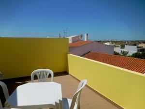 balcón con mesa y sillas en el techo en Casa Amarela, en Pêra