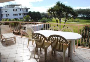 a dining area with chairs, tables and chairs at Surfside On The Beach in Buddina
