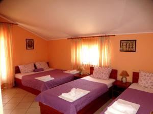 a bedroom with two beds and a window at Guest House Villa Živanović in Herceg-Novi