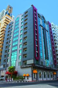 a large building with many windows on the side of it at Al Maha Regency Hotel Suites in Sharjah