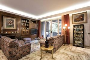 a living room with two couches and a television at Villa Paquita in Calella