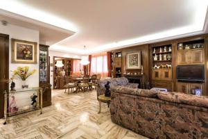 a living room with a couch and a dining room at Villa Paquita in Calella