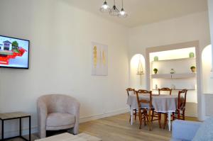 a living room with a dining room table and chairs at 2 Pièces Liberté Plein Centre in Saint-Raphaël
