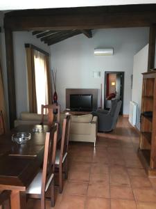 a living room with a table and a couch at Apartamentos Jardines de Lorca in Lorca