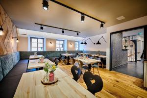 a restaurant with tables and chairs in a room at Hotel & Restaurant Herzstück Waldkirchen in Waldkirchen