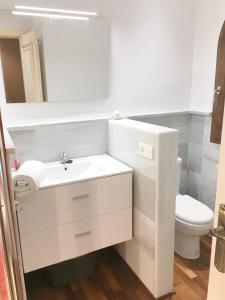 a bathroom with a white sink and a toilet at VILLA CORASAO LUXURY in La Zubia