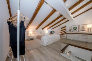 a attic bedroom with a bed and a mirror at Villa Bella in Banjol +40 photos