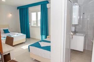 a small room with two beds and a bathroom at Apartmani Nela Sutomore in Sutomore +130 photos