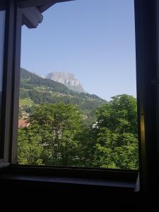 a window with a view of a mountain at Studio Duplex Place de la Grenette in Sallanches