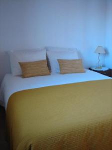 מיטה או מיטות בחדר ב-Casa da Avó Mina