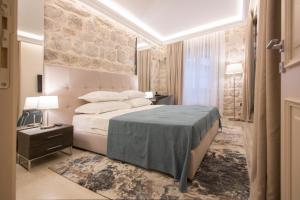 Postel nebo postele na pokoji v ubytování Heritage Hotel Leon Coronato