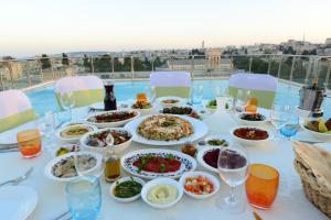 a table with plates of food on it with a view at St. George Hotel in Jerusalem