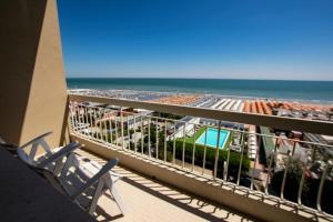 a balcony with a view of the beach and the ocean at Color Miami Beach Family Hotel in Milano Marittima