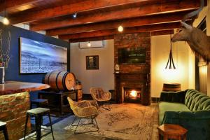 a living room with a couch and a fireplace at Swartberg Hotel, Cork Tree Collection in Prince Albert