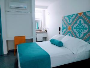 Postel nebo postele na pokoji v ubytování Akuamarina Hotel