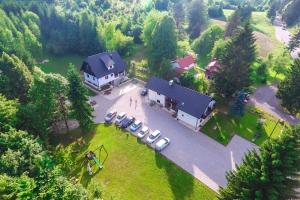 an aerial view of a house with a group of parked cars at B&B Lady of the Lake in Jezerce