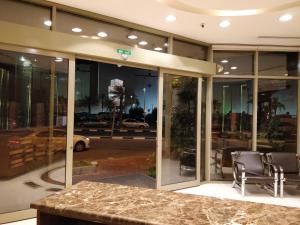 a lobby with a table and chairs in a building at Tanal Serviced Apartments in Al Khobar