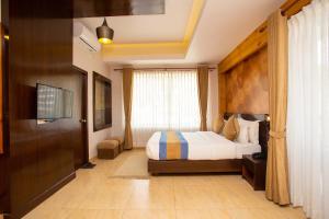 Un pat sau paturi într-o cameră la Hotel Lake Paradise