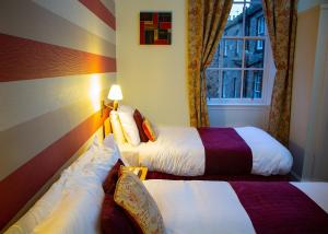 a bedroom with a bed and a lamp at The Broughton Hotel in Edinburgh