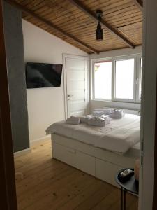 a bedroom with a bed and two windows at Lascăr Catargiu Vila in Bucharest