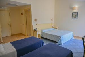 Postel nebo postele na pokoji v ubytování Hotel Baja Romantica