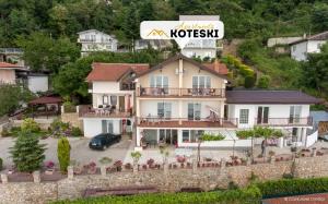 una casa en una colina con un cartel encima en Apartments Koteski, en Ohrid