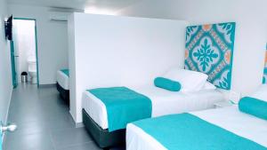 Postel nebo postele na pokoji v ubytování Akuamarina Hotel