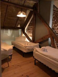 a room with three beds in a attic at Lascăr Catargiu Vila in Bucharest