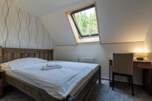 Tempat tidur dalam kamar di Parkhotel Harrachov