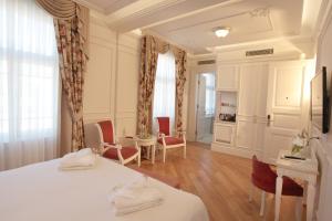 a bedroom with a bed and a table and chairs at Corinne Art & Boutique Hotel in Istanbul