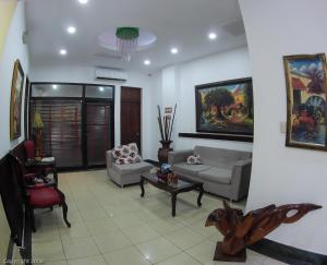 a living room with a couch and a table and chairs at Hotel Discovery in Santo Domingo