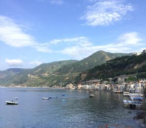 a body of water with boats in it with mountains at La Sciabica in Scilla