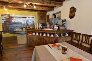 a kitchen with a table and a counter in a room at Vecchio Mulino Guest House in Aosta