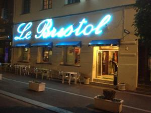 a lit up sign on the side of a restaurant at Hotel Le Bristol in Valenciennes +8 photos