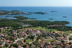 an aerial view of a town and islands in the water at Ina in Funtana