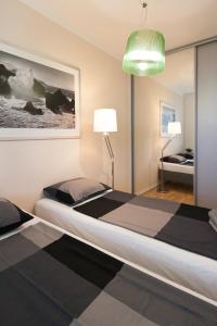 a bedroom with two beds and a green light at After Six Apartment in Bratislava