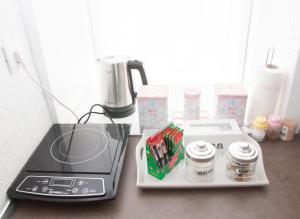 a counter with a coffee maker and a blender at Bistrik Rose Apartment in Sarajevo