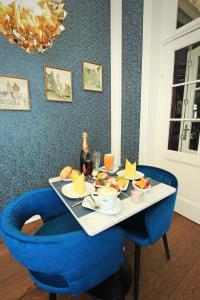 a table with a plate of food and a bottle of champagne at Monopol Boutique Hotel in Bremen