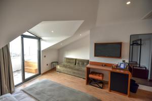 A television and/or entertainment centre at La Farine Rooms