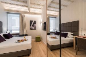 a hotel room with two beds and a table with food at Laurina 33 in Rome