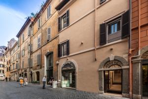 a street in an old town with people walking down it at Laurina 33 in Rome