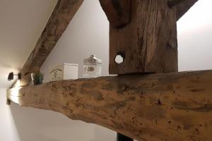 a wooden shelf with a jar on top of it at La Cabane in Penne-dʼAgenais