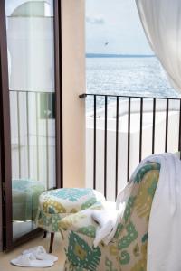 a white bird sitting on a chair in front of a window at I Bastioni San Domenico - Boutique Hotel in Gallipoli