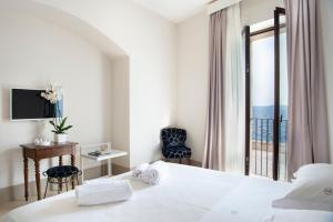 a hotel room with a bed and a view of the ocean at I Bastioni San Domenico - Boutique Hotel in Gallipoli